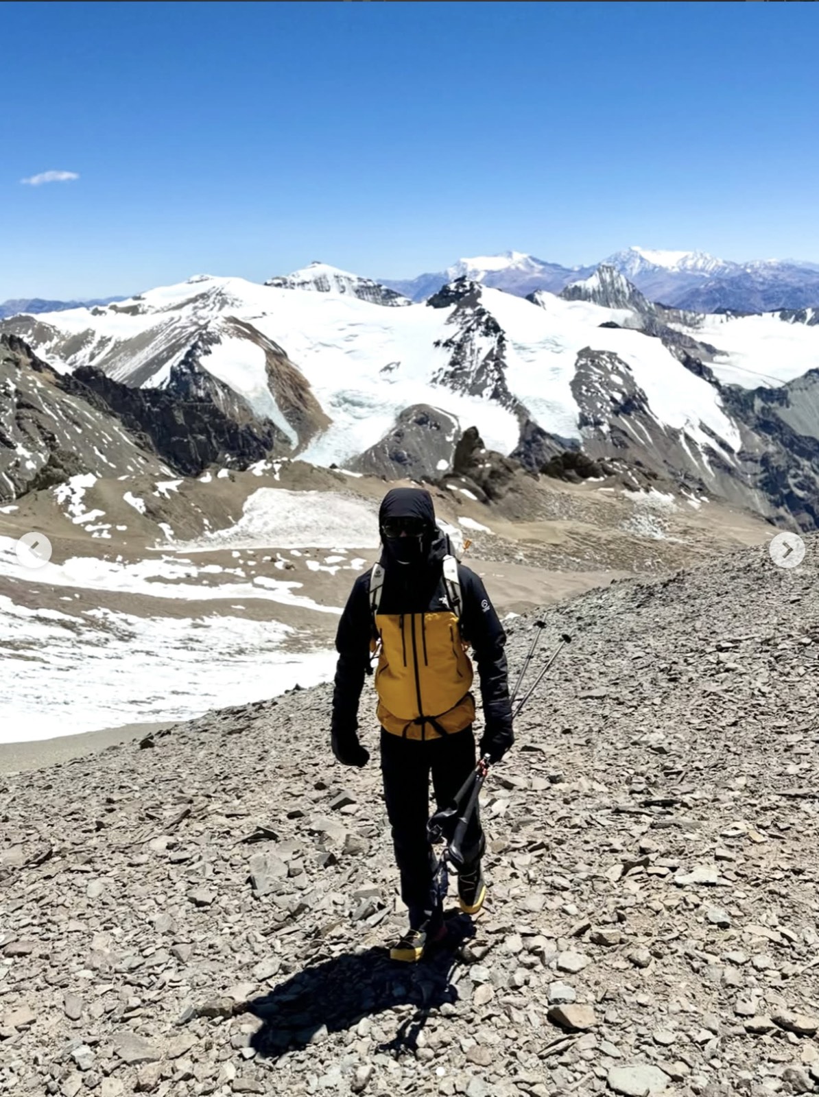 James Jackson walking up a scree path towards the snow on Aconcagua