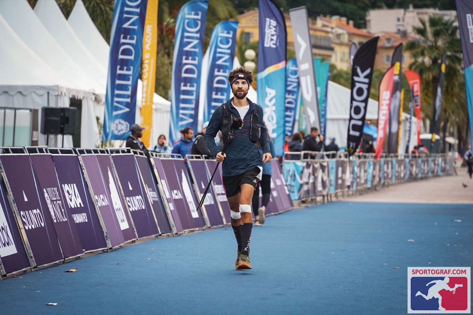 James Jackson running down the finish straight of the Nice Côte d'Azur by UTMB 100M